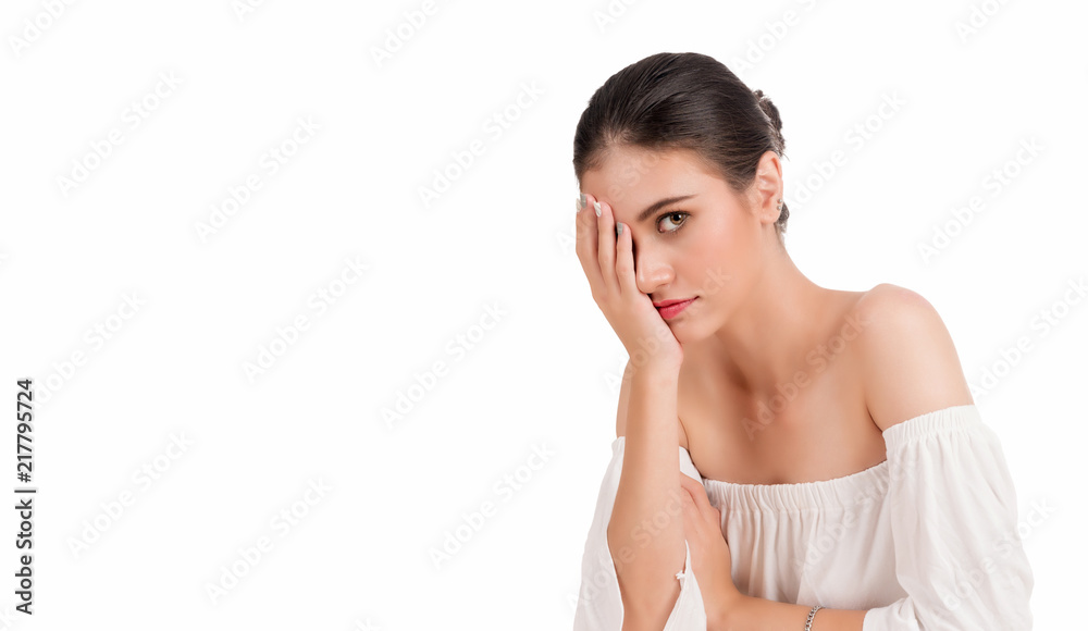 Attractive young woman covering her face with one hands while looking at camera on isolated white background with copy space. Attractive young woman covering her face with one hands while looking at camera on isolated white background with copy space.