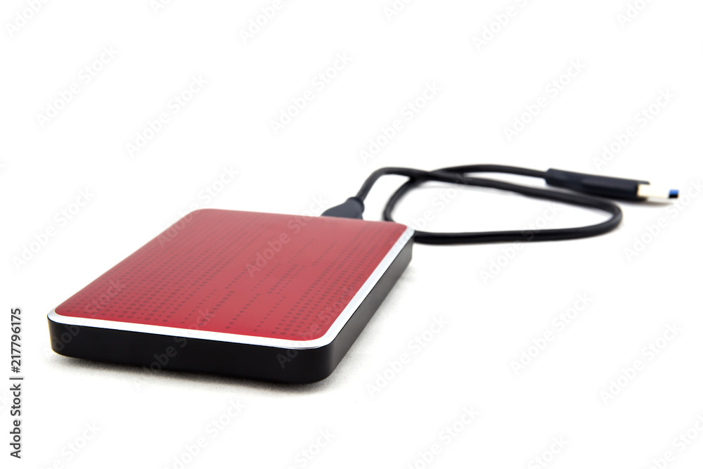 Red external hard drive with usb cable on the white background. Red external hard drive with usb cable on the white background.