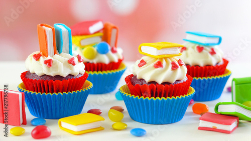 Bright colorful Back to School theme cupcakes with candy sugar art book topper decorations, children's party celebrations.
