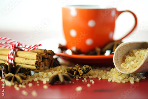 Coffee sugar, cinnamon and star anise coffee sweetener macro closeup on vintage red wood table, selective focus.