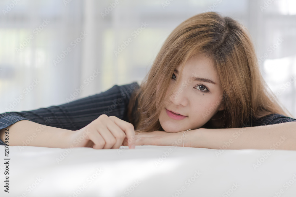 Close up of charming happy girl. Beautiful Asian woman in white room Close up of charming happy girl. Beautiful Asian woman in white room