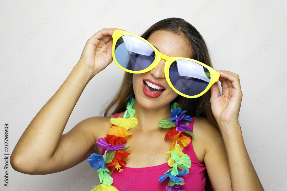 Girl ready for Carnival party. Young woman with big funny sunglasses and  carnival garland smile at camera on gray background. Stock Photo | Adobe  Stock