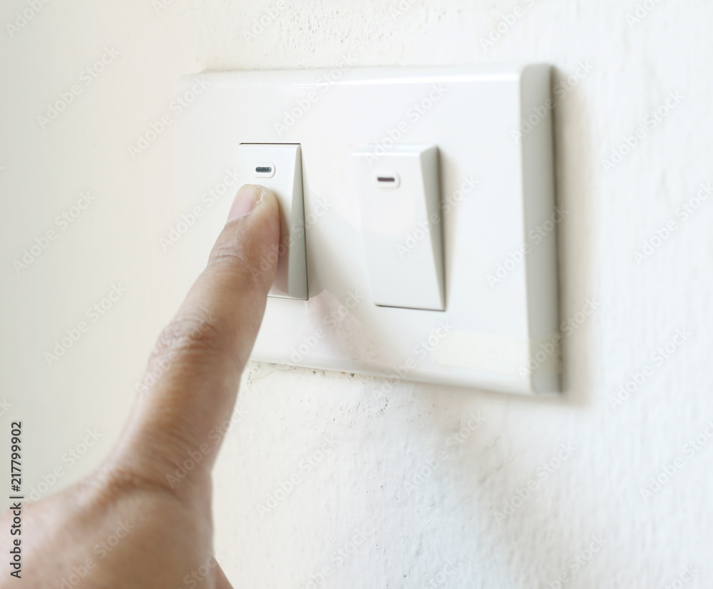 hand switching light power switch on or off. hand switching light power switch on or off.
