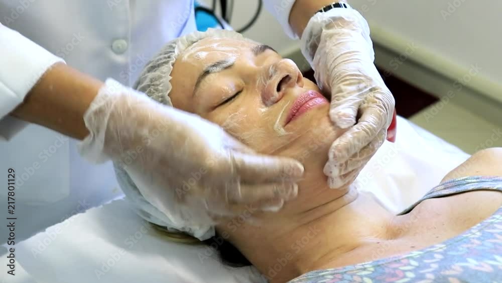 The cosmetologist performs skin cleansing in woman The cosmetologist performs skin cleansing in woman