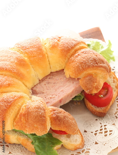 Luncheon meat in croissant sandwich