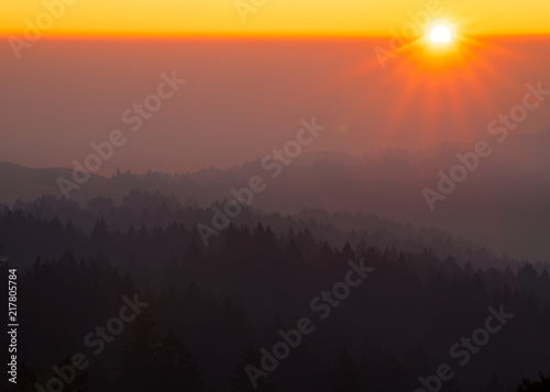 Smoke from the summer 2018 California wildfires glows under the setting sun