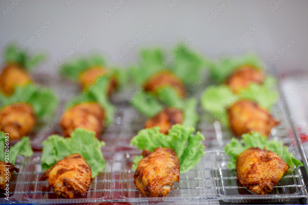 Fried chicken, small pieces fit the mouth and contains green vegetables. Make it look more delicious.