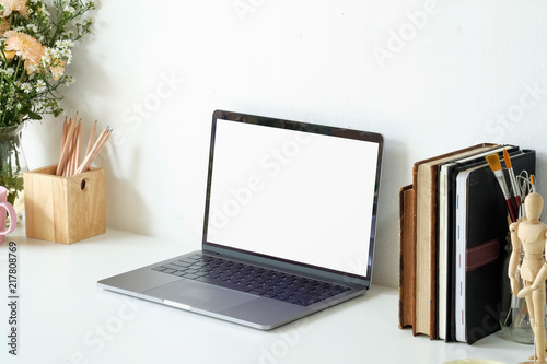 Loft workspace Blank screen laptop on white desktop.