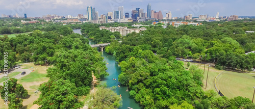 Panorama aerial view Downtown from Barton Creek in Greenbelt at Zilker Metropolitan Park south Austin with summer blue cloud sky. Located at eastern edge of Hill Country, is the state capital of Texas photo