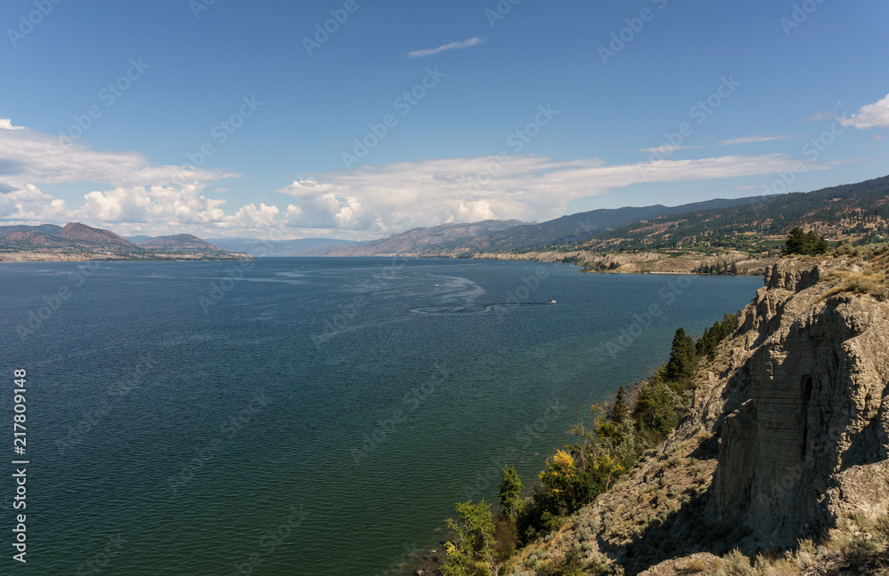 Okanagan lake at summer day with clouds on the sky.