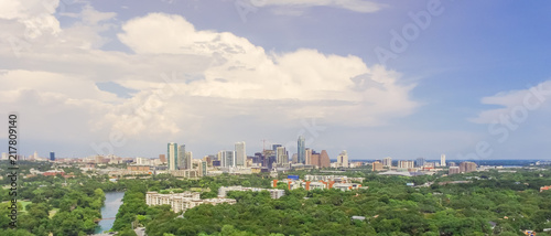 Panorama aerial view Downtown from Barton Creek in Greenbelt at Zilker Metropolitan Park south Austin with summer blue cloud sky. Located at eastern edge of Hill Country, is the state capital of Texas photo