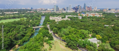 Panorama aerial view Downtown from Barton Creek in Greenbelt at Zilker Metropolitan Park south Austin with summer blue cloud sky. Located at eastern edge of Hill Country, is the state capital of Texas photo