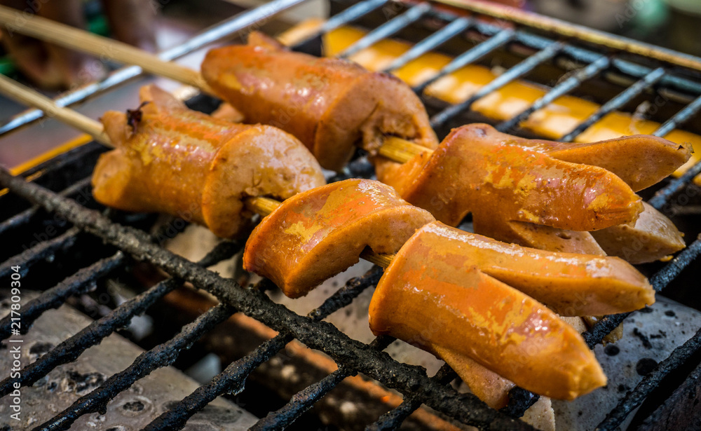 Close up of grilling sausages on barbecue grill