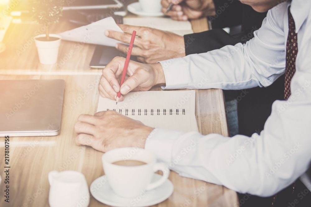 Businessmen use a pencil point to business document during discussion at meeting,Vintage filters Businessmen use a pencil point to business document during discussion at meeting,Vintage filters