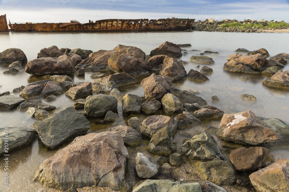 The beach with stones. Big stones on the beach. Morning inflow of water. Bulgaria, Burgas, Nessebar, Olympic Hope beach The beach with stones. Big stones on the beach. Morning inflow of water. Bulgaria, Burgas, Nessebar, Olympic Hope beach