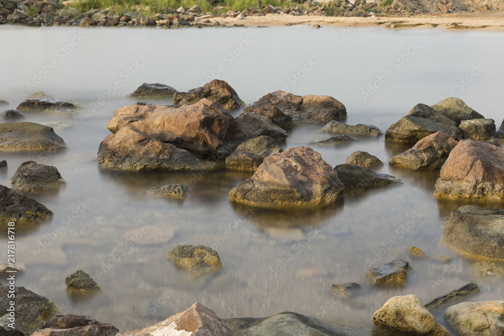 The beach with stones. Big stones on the beach. Morning inflow of water. Bulgaria, Burgas, Nessebar, Olympic Hope beach The beach with stones. Big stones on the beach. Morning inflow of water. Bulgaria, Burgas, Nessebar, Olympic Hope beach
