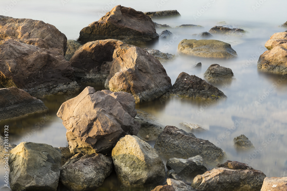 The beach with stones. Big stones on the beach. Morning inflow of water. Bulgaria, Burgas, Nessebar, Olympic Hope beach The beach with stones. Big stones on the beach. Morning inflow of water. Bulgaria, Burgas, Nessebar, Olympic Hope beach