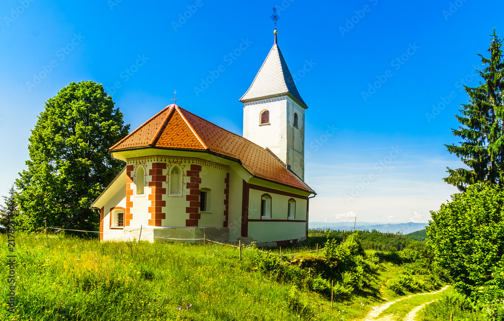 View on small church of Cerkev sv. Ahaca by kamnik in the mountains of Slovenia