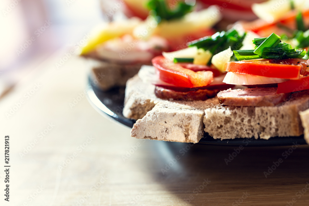 Delicious healthy homemade sandwiches with vegetables and cold cuts on the plate. Shallow depth of focus. Delicious healthy homemade sandwiches with vegetables and cold cuts on the plate. Shallow depth of focus.