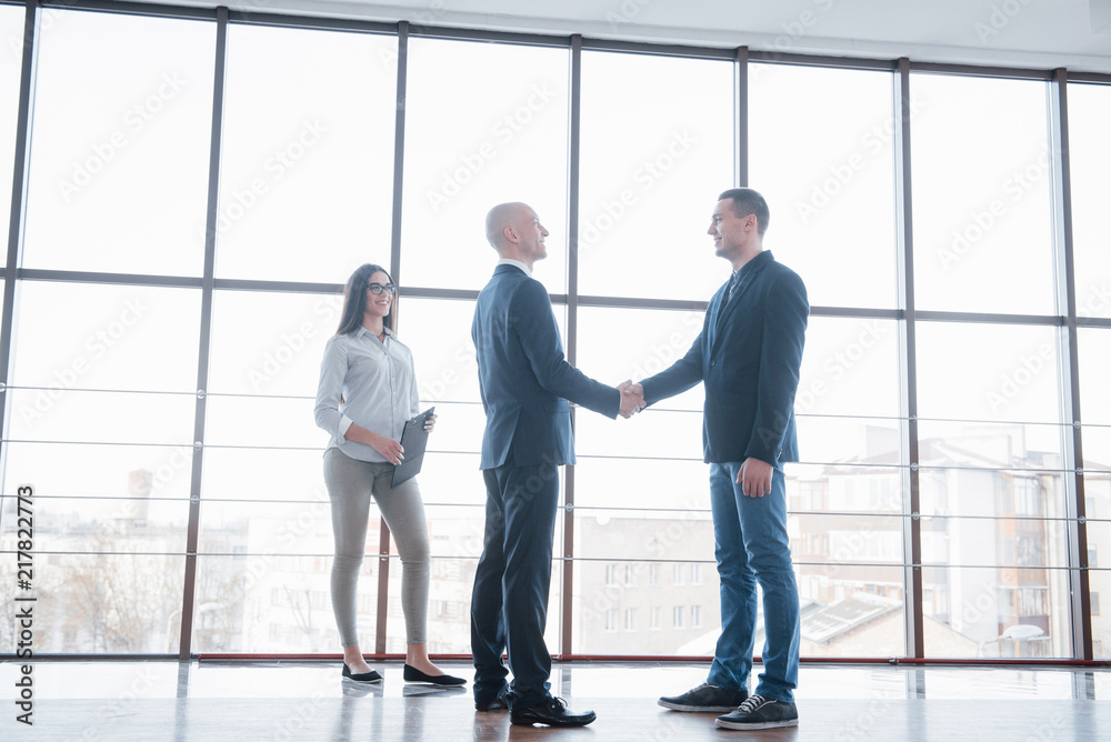Two confident business man shaking hands during a meeting in the office, success, dealing, greeting and partner concept Two confident business man shaking hands during a meeting in the office, success, dealing, greeting and partner concept
