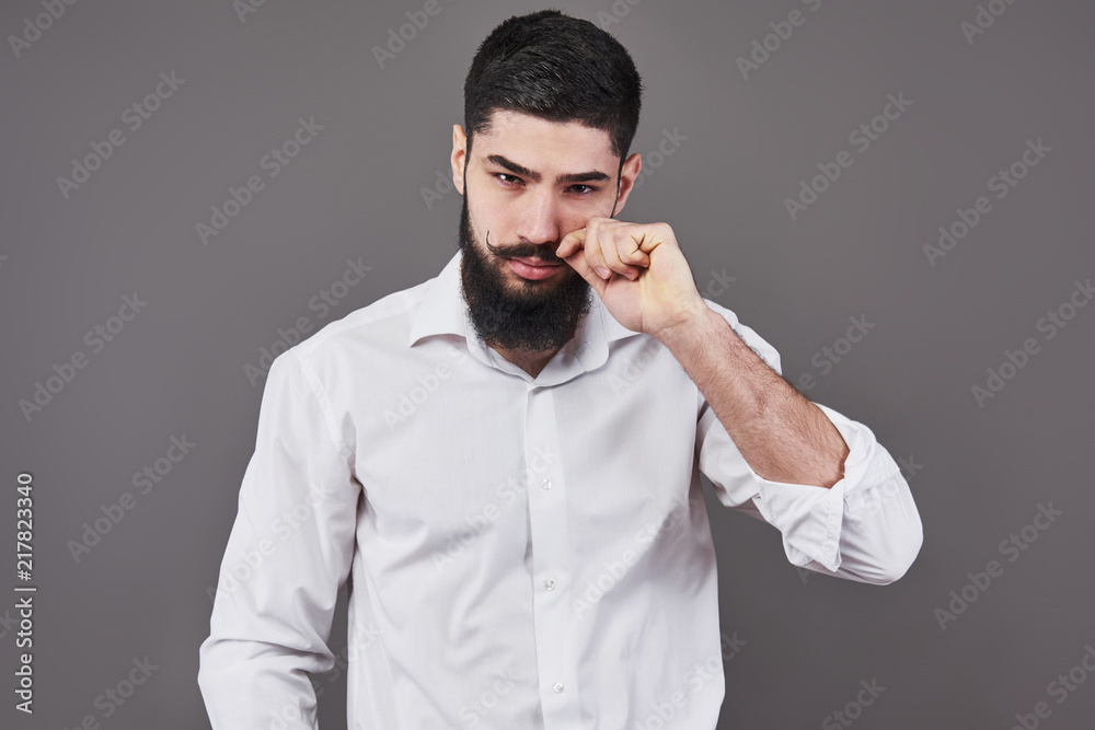 Hipster with serious face. Feeling and emotions. Guy or bearded man on grey background. Barber fashion and beauty. Man with long beard and mustache, copy space Hipster with serious face. Feeling and emotions. Guy or bearded man on grey background. Barber fashion and beauty. Man with long beard and mustache, copy space