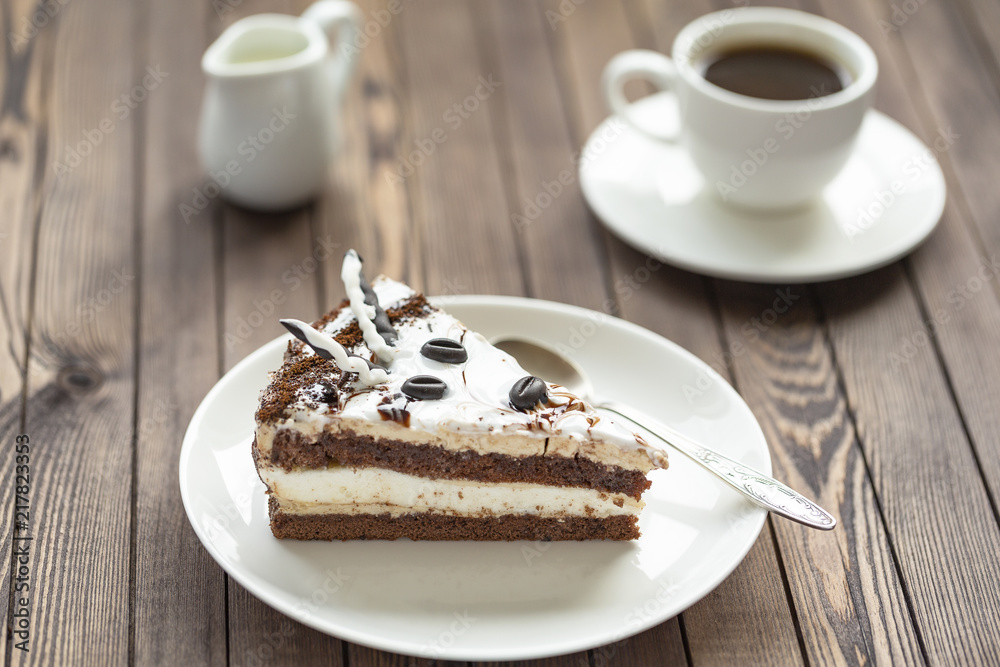 Souffle cake with chocolate sauce and coffee, on a wooden table. Souffle cake with chocolate sauce and coffee, on a wooden table.