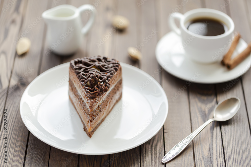 Dessert souffle with chocolate sauce and nuts on a white plate, on a wooden table. Dessert souffle with chocolate sauce and nuts on a white plate, on a wooden table.
