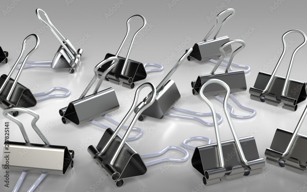 Obraz premium Several binder clips placed on the grey background