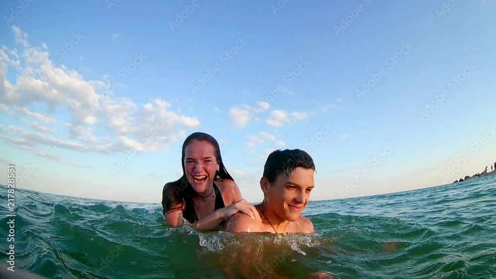  beach water splashing: young teens having summer beach party fun. slow mo stock video