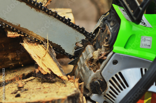 Chainsaw saws a log close up, large bars