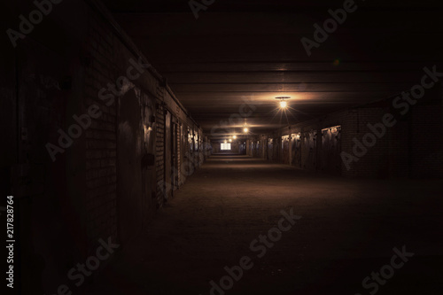 Dark long hallway with metal gates