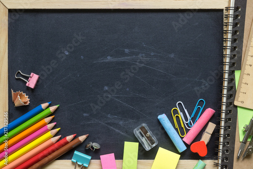 Empty Blank Black Chalk board Background with wooden frame and School supplies, ideal for back to school and education background.