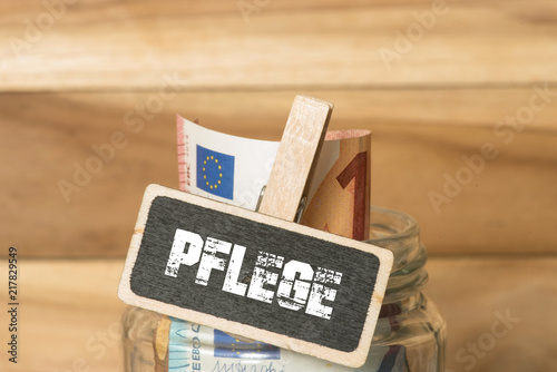 Ein Einmachglas mit Euro Geldscheinen und die Pflege photo