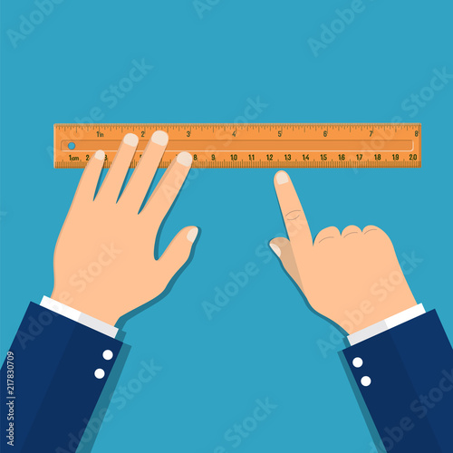 Plastic measuring ruler in hand. photo