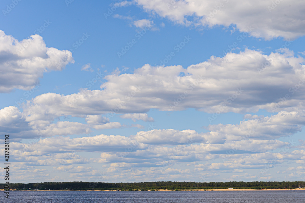 Volga river landscape with a distant wooded shore and sky with clouds
