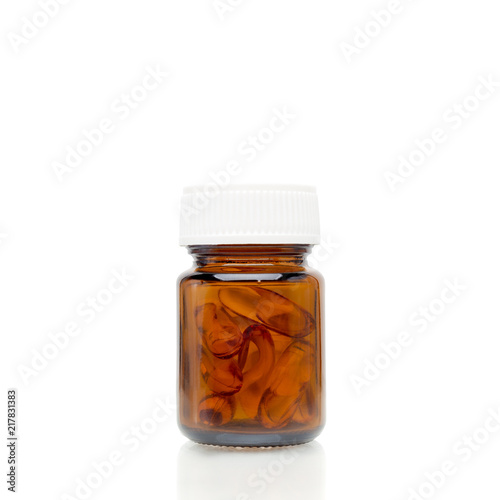 pills of fish oil capsule in glass bottle