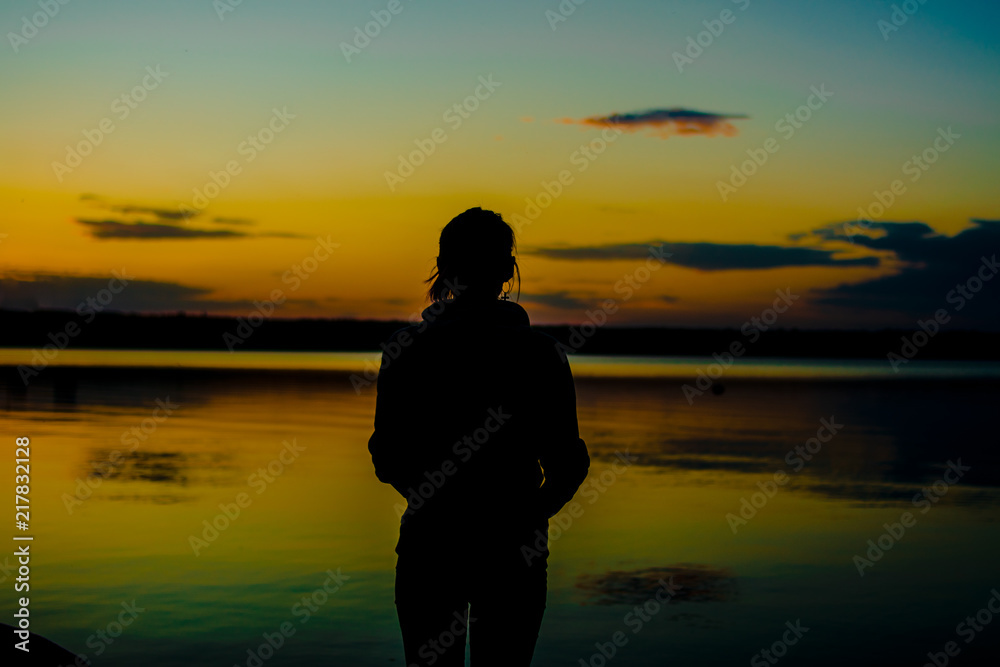 Silhouette of a girl watching sunset