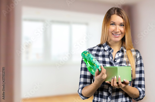 Portrait of a happy smiling girl opening a gift box