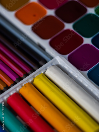 Watercolor paints, color pencils and plasticine. For children's creativity. School supplies. Color background.