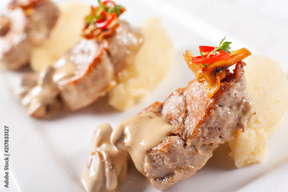 Pork Medallions with Mashed Potato and Mushrooms. Pork tenderloin on a white plate, good serving. restaurant menu Pork Medallions with Mashed Potato and Mushrooms. Pork tenderloin on a white plate, good serving. restaurant menu