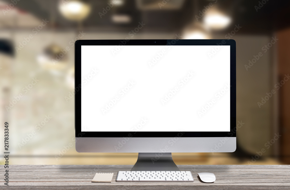 Modern computer monitor with blank screen on table Modern computer monitor with blank screen on table