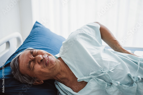 Old asian patient suffering from back pain, back ache