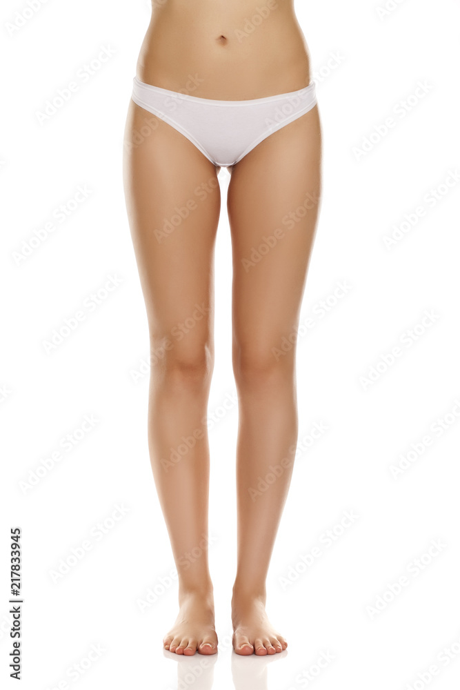Female bare legs with white panties on white background