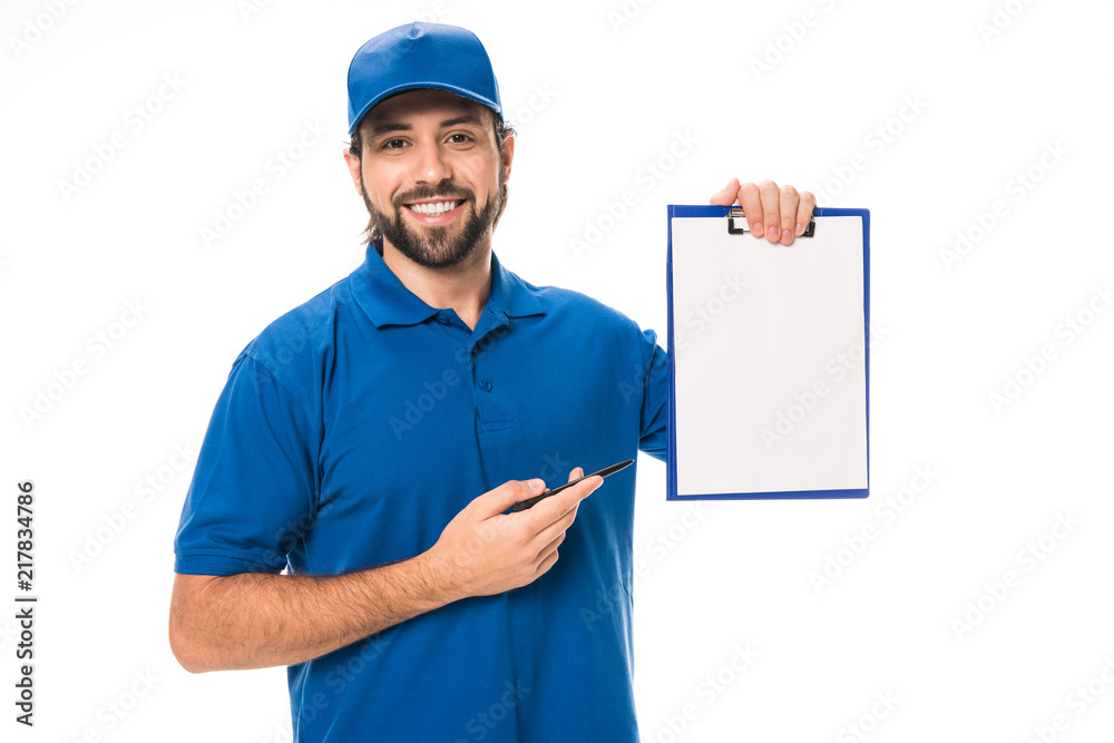 handsome young delivery man pointing at blank clipboard and smiling at camera isolated on white handsome young delivery man pointing at blank clipboard and smiling at camera isolated on white