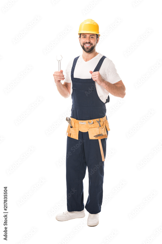 handsome happy workman holding wrench and smiling at camera isolated on white handsome happy workman holding wrench and smiling at camera isolated on white
