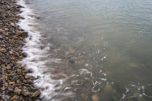 high angle view of the Sea waves splash on stones.