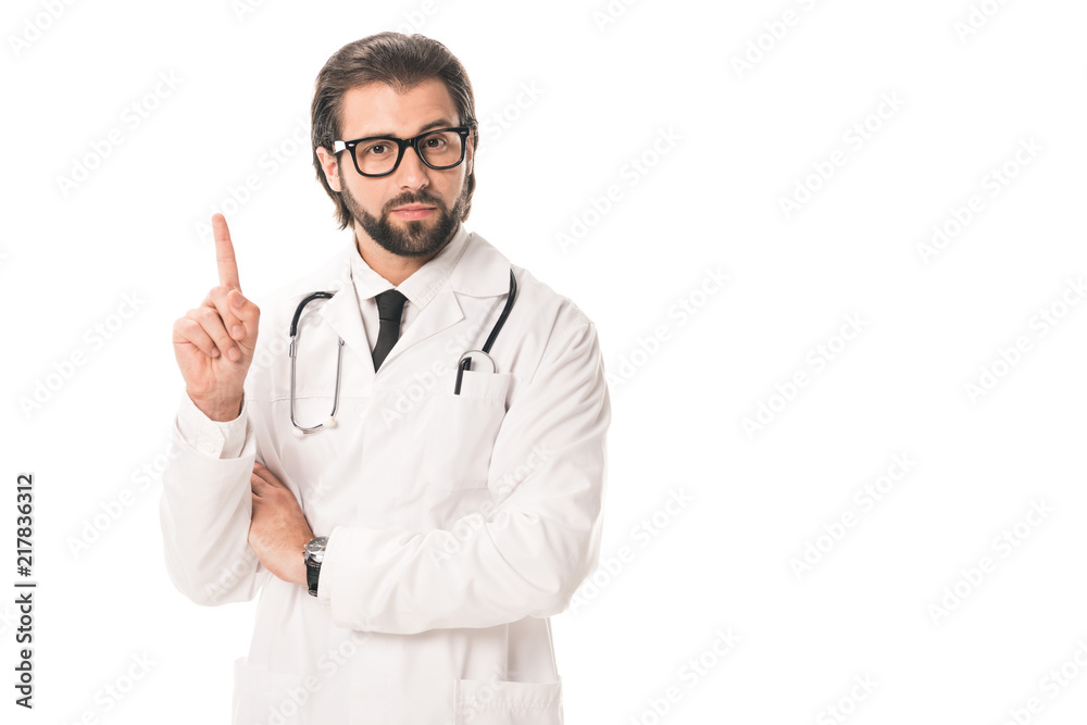handsome doctor in eyeglasses and white coat pointing up with finger and looking at camera isolated on white handsome doctor in eyeglasses and white coat pointing up with finger and looking at camera isolated on white