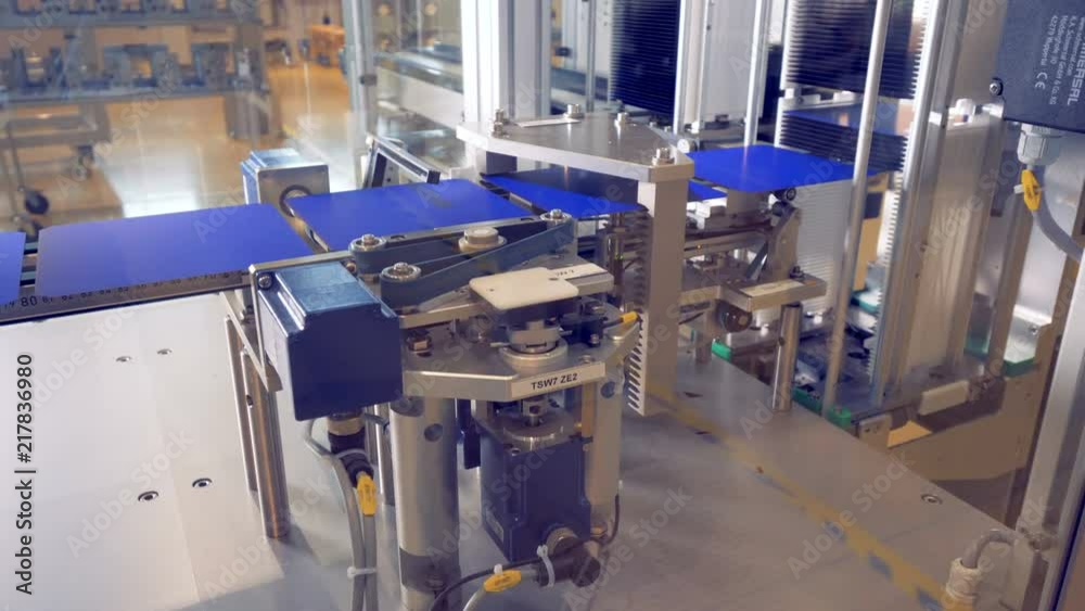 Solar module cells are being adjusted while moving along the conveyor belt. Solar module cells are being adjusted while moving along the conveyor belt.