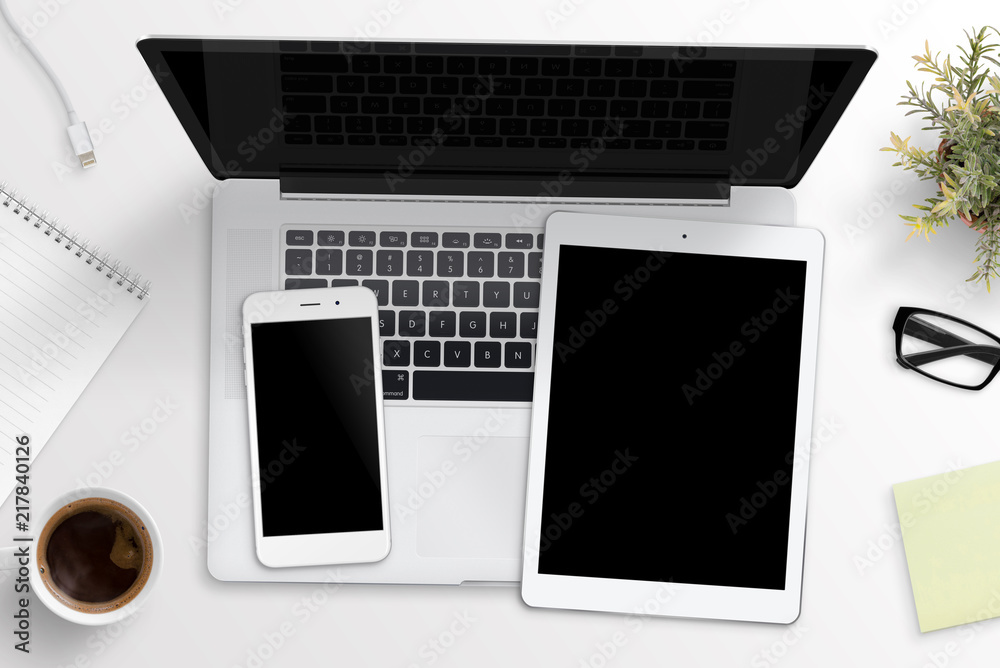 Smart phone and tablet mockup on laptop keyboard. Office desk concept. Top view. Smart phone and tablet mockup on laptop keyboard. Office desk concept. Top view.