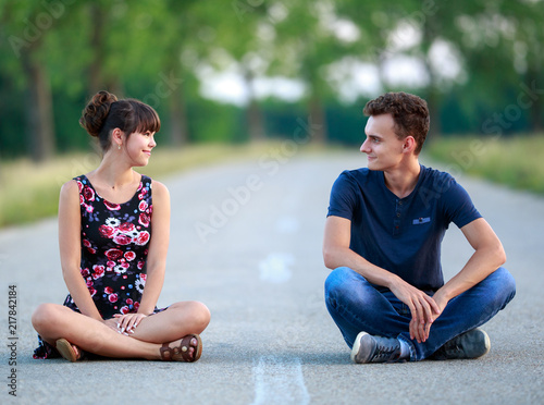Couple sitting in the middle of the road